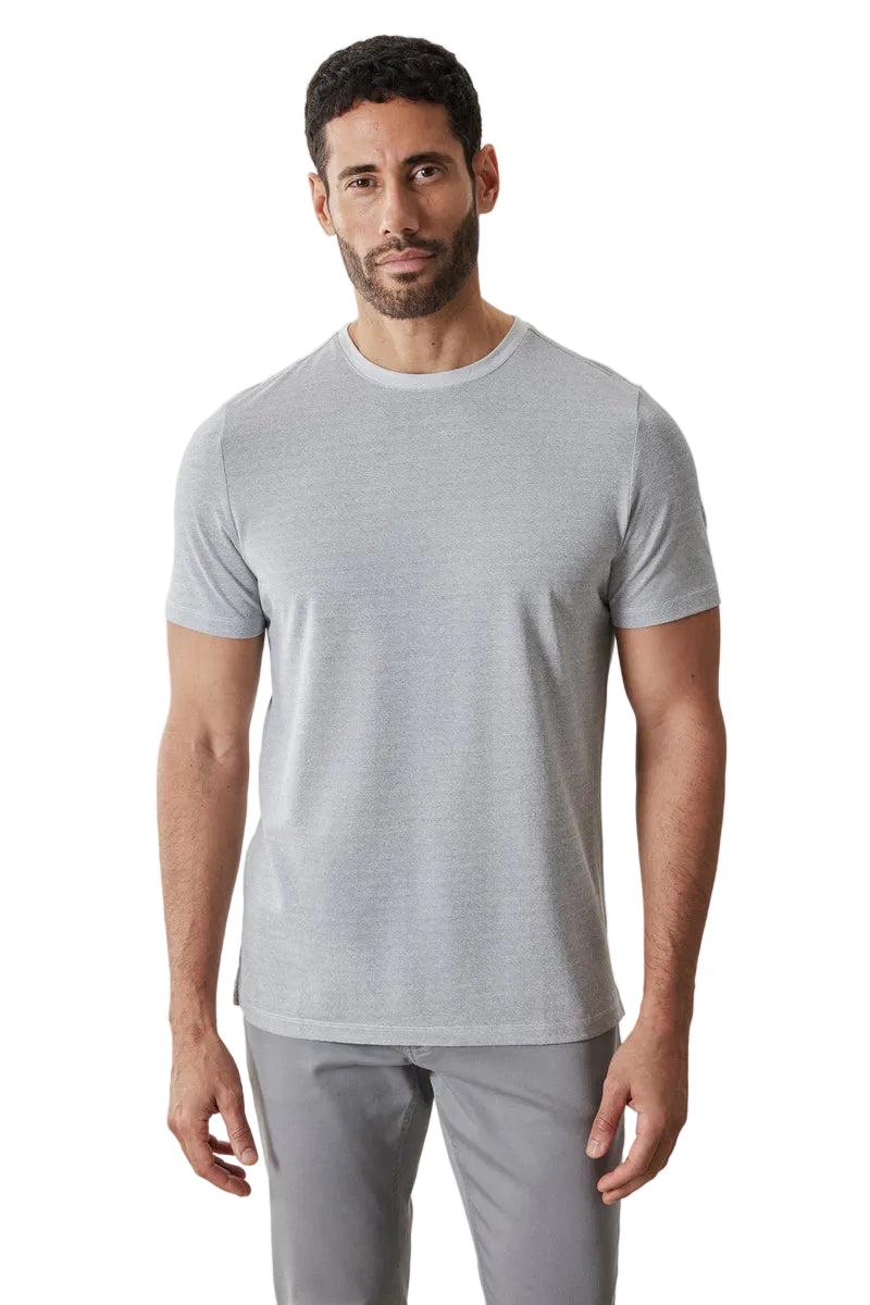 Man wearing a gray t-shirt and pants on a light gray background