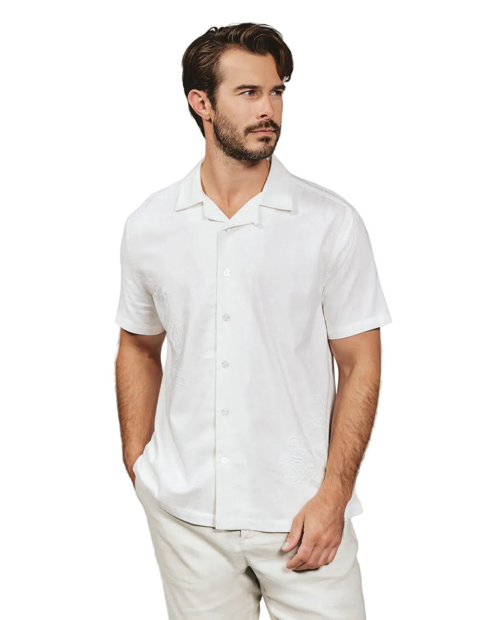 Man wearing a white short-sleeve shirt against a gray background