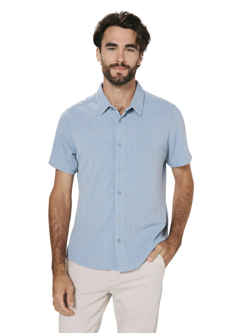 Man wearing a light blue short-sleeve shirt and light pink pants on a white background