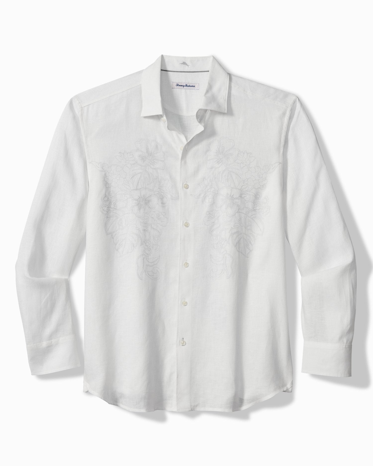 A white long-sleeve button-up shirt with a subtle tonal embroidered pattern on the front, displayed on a clean white background.